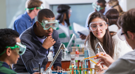 Four students working in a science lab 